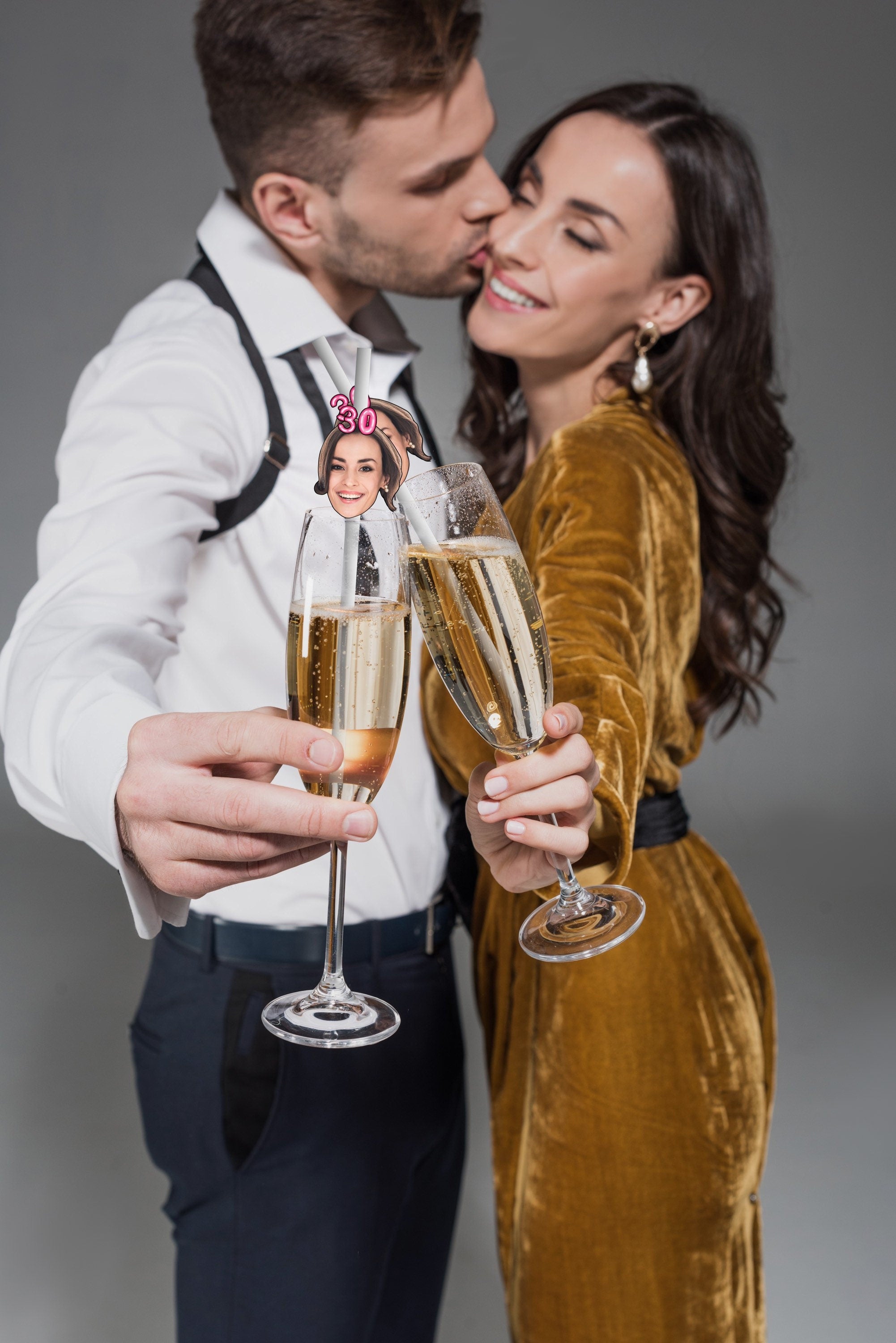 Happy couple toasting with custom party straws featuring names and wedding date, adding a personalised touch to their special day.