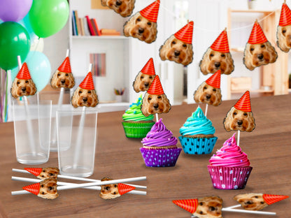 A cheerful decoration showcasing a cut-out of a dog's head wearing a bright party hat, perched atop a delicious cupcake, ideal for a pet's birthday celebration. Also examples of a pet banner and pet straws!