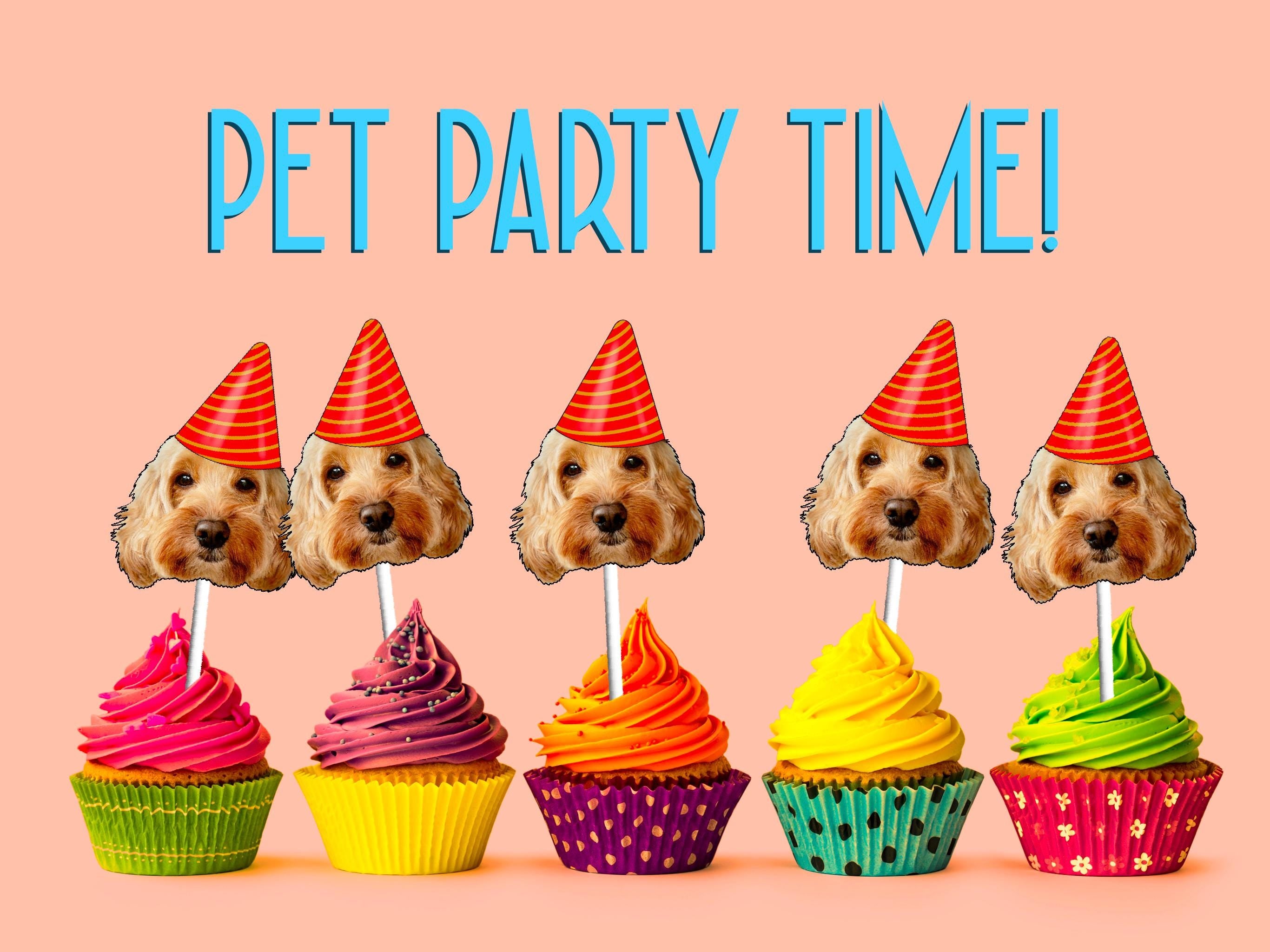 Dog or cats cake decorations. A whimsical decoration featuring a cut-out of a dog&#39;s head on a stick, placed on top of a colorful cupcake, perfect for celebrating a pet&#39;s birthday party.