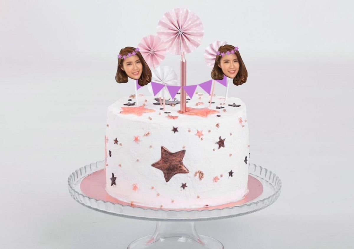 Birthday party cake with custom face bunting topper, pink and purple accents, and gold balloon backdrop. Perfect personalised decoration for birthdays, weddings, and celebrations.