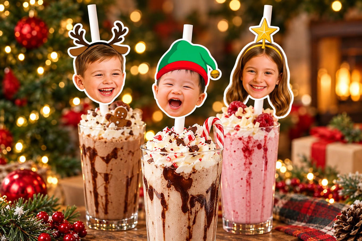 Text-free close-up of kids' christmas photographic head toppers on white paper straws in tall glasses.