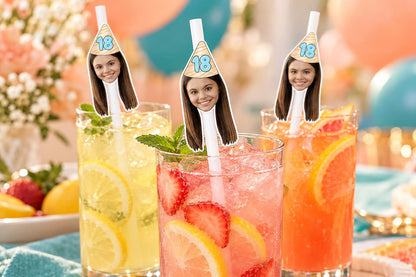 Text-free close-up of 18th birthday photographic head toppers on white paper straws in tall glasses.